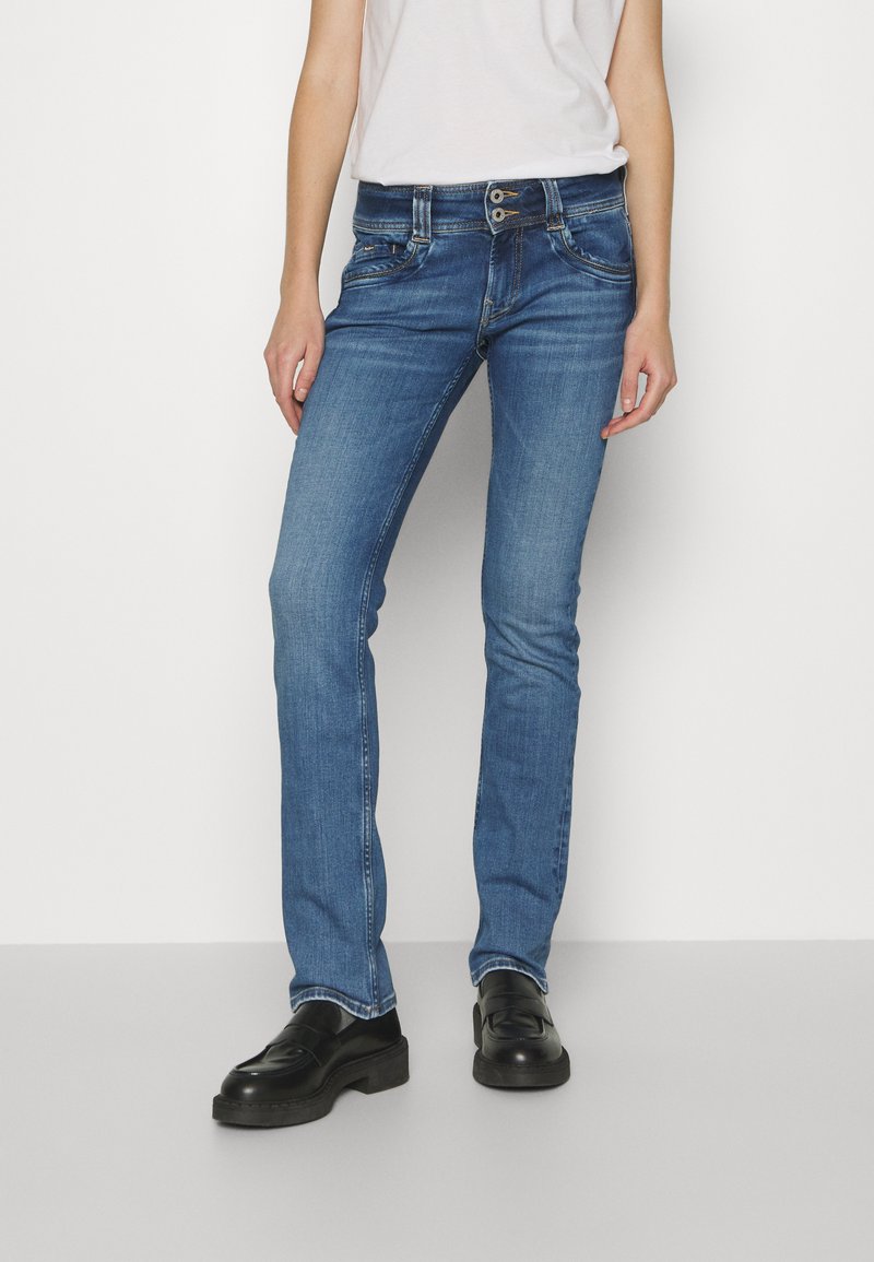 Hochrise-BlaJeans aus Denim, mit geradem Bein, zwei Vordertaschen und einem Knopfverschluss mit kontrastierenden Nähdetails.