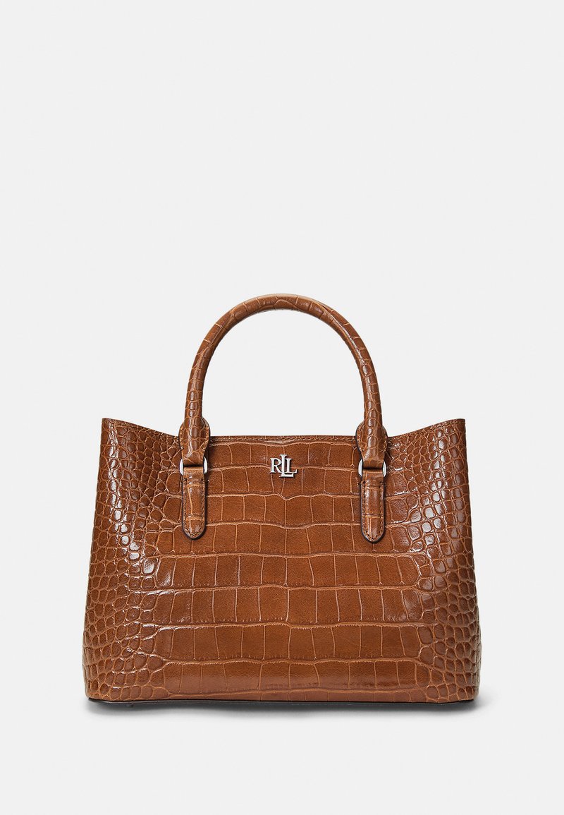 Bolsa de mão em pele castanha com textura de crocodilo, com duas alças arredondadas, apresentando um detalhe em logotipo prateado na parte frontal e base plana.