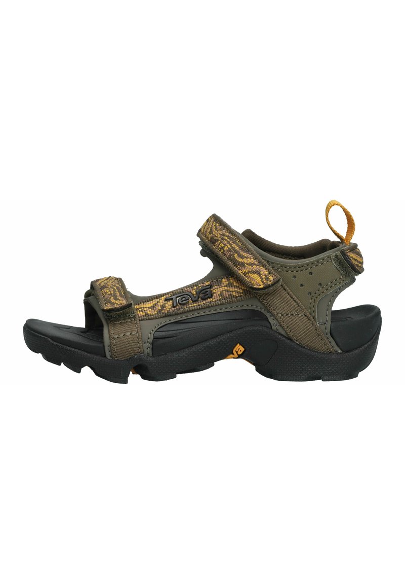 Teva sandals with a dark green fabric upper featuring a camouflage pattern, velcro straps, and a black rubber sole. Includes a rear pull tab.