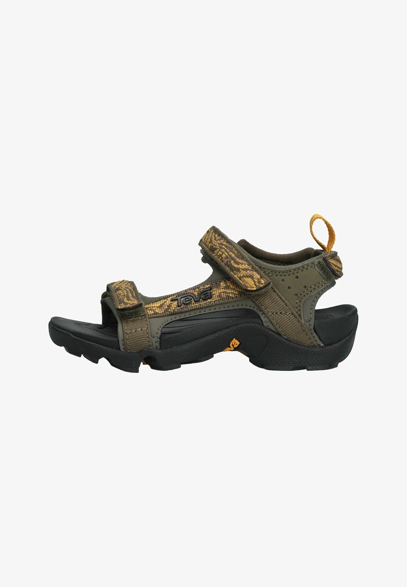 Teva sandals with a dark green fabric upper featuring a camouflage pattern, velcro straps, and a black rubber sole. Includes a rear pull tab.