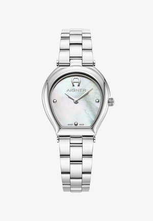 Srebrna ura iz nerjavečega jekla s perlastim številčnico, edinstvene kapljaste oblike in logom Aigner. Ima kazalce za ure in minute; izdelano v Švici.