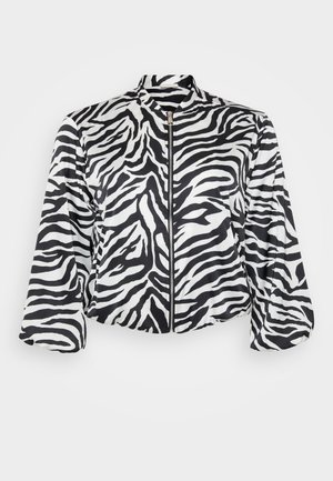 Black and white cropped jacket with zebra print, featuring a stand collar and front zipper. Made of lightweight, smooth fabric.