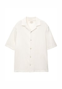 Kort-ärmelig overhemd met knopen in licht ivoor. Gemaakt van zachte stof met een losse pasvorm en een klassieke campkraag. Voorzien van een subtiele textuur.