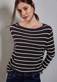 Gestreifter Strickpullover mit weitem Halsausschnitt. Dunkelblauer Hintergrund mit weißen horizontalen Streifen. Weiche Textur und lässige Passform.