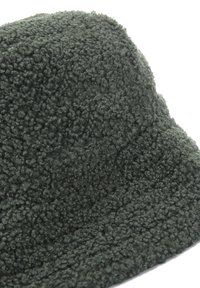 Cappello a secchiello verde, dalla texture soffice e morbida. Forma rotonda con un ampio bordo, caratterizzato da un motivo superficiale uniforme.