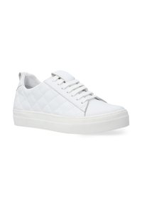 White sneaker featuring quilted texture, flat laces, a rounded toe, and a thick rubber sole. Slip-on design with a heel tab for easy wear.