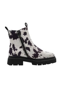 Bottes chelsea imprimées vache en matériau texturé, avec deux fermetures éclair sur les côtés, une semelle épaisse noire et des accents noirs contrastants.