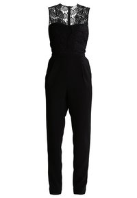 Svart jumpsuit med blommig spetskorsett och helsvarta byxor, med figursydd midja och detalj med nyckelhål bak.