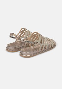 Metallische gouden sandalen met gekruiste banden, versierd met rhinestone-accenten en een verstelbare gesp. Gladde, platte zool en open ontwerp.