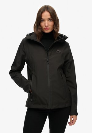Black waterproof jacket with a zip closure, hood, and two side pockets. Features a logo on the chest, sleek design, and smooth texture.