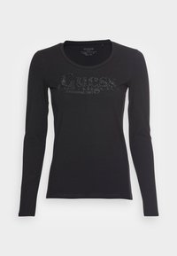 Zwarte longsleeve T-shirt van zachte katoen, met een ronde halslijn en een glanzend "Guess" logo op de voorkant.