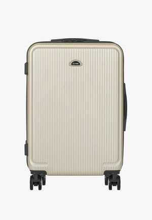 Kremowa walizka twarda z pionowymi żebrowaniami, czarnymi kółkami oraz czarnym logo marki umieszczonym centralnie w górnej części przedniego panelu.