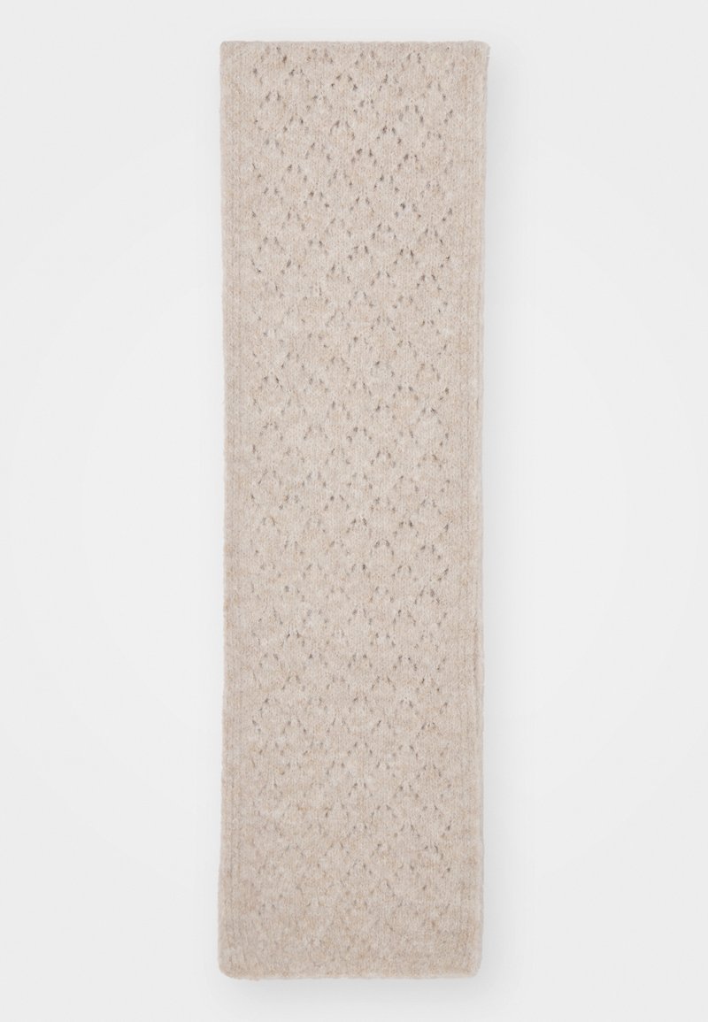 Beige kuvioitu huivi, jossa on teksturoitu neulottu muotoilu timanttikiemuroilla, valmistettu pehmeästä materiaalista. Mitat ovat pitkiä ja suorakulmaisia.