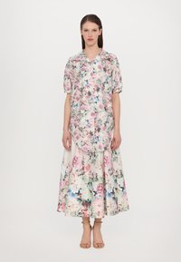 Floral print shirt and skirt set; short sleeves; light fabric; features pink, blue, and green flowers; hemline scoops at the front and back.