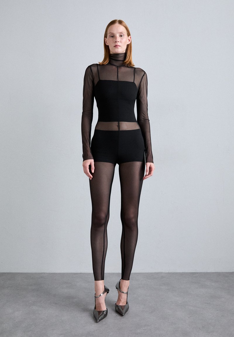 Black bodysuit with long, sheer mesh sleeves, a high collar, and matching sheer leggings. Includes pointed heels, showcasing a streamlined design.