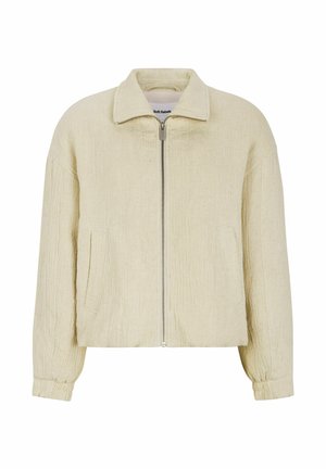 Beige bomberjack met een gestructureerde stof, voorrits, korte kraag en zijzakken. Het heeft elastische boorden en een relaxte pasvorm.