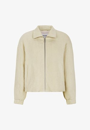 Beige bomberjack met een gestructureerde stof, voorrits, korte kraag en zijzakken. Het heeft elastische boorden en een relaxte pasvorm.