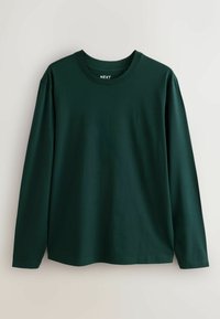 Tumši zaļš garo pieduru krekls, izgatavots no kokvilnas auduma. Tam ir apaļa kakla izgriezuma forma un neliels logs uz krūtīm. Mīksta, gluda tekstūra.