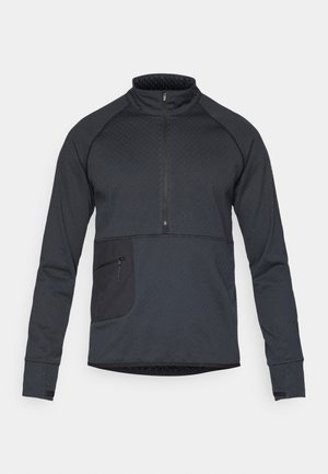 Black athletic pullover with a half-zip collar, textured fabric, raglan sleeves, and a side zip pocket. Features contrasting fabric accents.