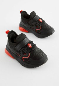 Baskets de sport noires et rouges avec un motif de toile d'araignée, tige en mesh, sangle ajustable et accent Spiderman sur la languette.