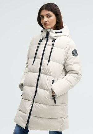 Padded beige coat with a hood, featuring a front zipper, black accents, and a round logo patch on the sleeve. Textured quilted design.