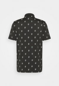 Black short-sleeve polo shirt featuring a repeating white and green geometric pattern, with a classic collar and soft texture.