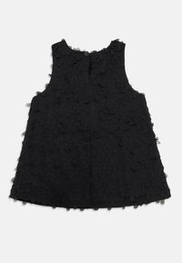 Black sleeveless dress featuring a textured pattern of overlapping petal shapes, round neckline, and back button closure.