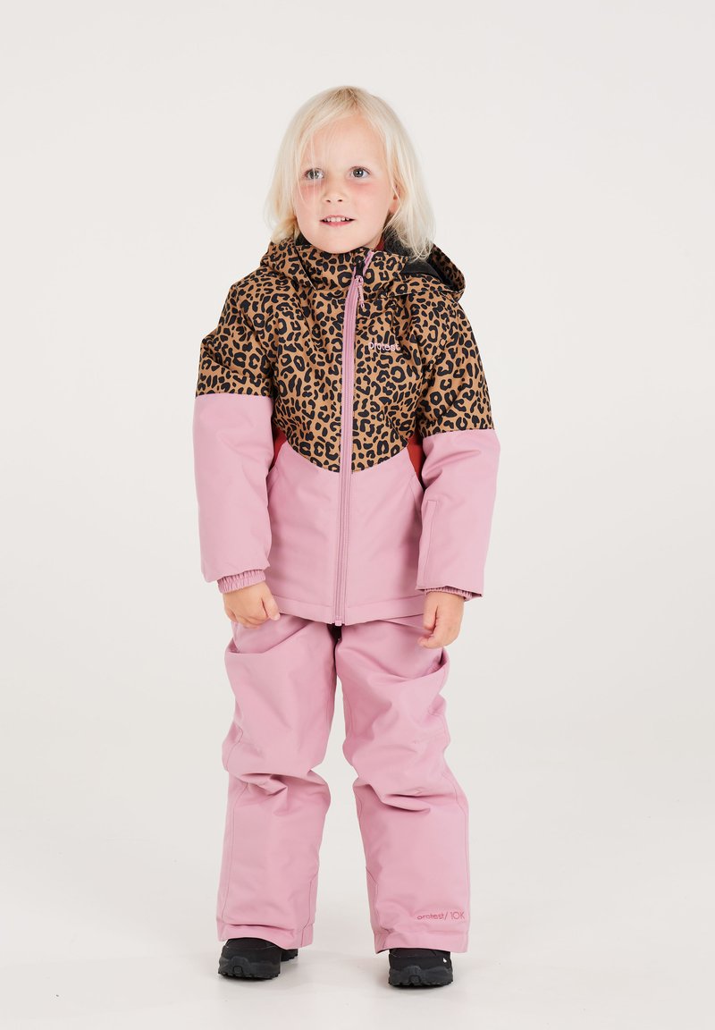 Ge padded Winterjacke mit einem braunen Leopardenmuster oben und einem pinken unteren Abschnitt, kombiniert mit passenden pinken Hosen und schwarzen Stiefeln.