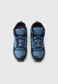 Blue trekking shoes with mesh upper, black accents, padded collar, and textured rubber sole. Features laces and rear pull tab for easy wear.