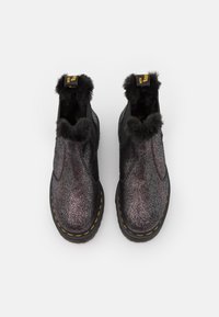 Black and silver ankle boots with faux fur trim and yellow stitching. Smooth, glossy finish with a slightly textured surface.