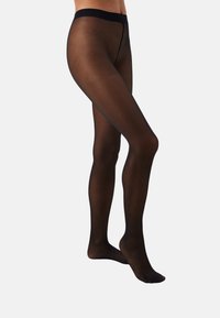 Collants noirs translucides avec une texture lisse, dotés d'une taille noire unie. Le design est près du corps et s'étend jusqu'aux chevilles.