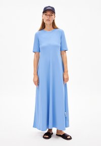 Robe midi bleue à manches courtes en tissu doux, avec un col rond et une coupe droite. Portez-la avec des sandales noires à enfiler.