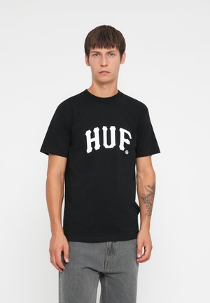Black cotton T-shirt featuring bold white "HUF" logo across the chest. Classic crew neck design, short sleeves, and relaxed fit.