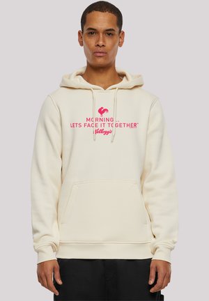 Beige hoodie with a front pocket, featuring a pink graphic text design stating, "MORNING ... LET'S FACE IT TOGETHER™ KELLOGG'S."