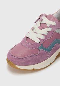 Rosa semsket og lær sneakers med hvite lissser, lys blå aksent og en teksturert gummisåle. Runde tå og polstret krage.