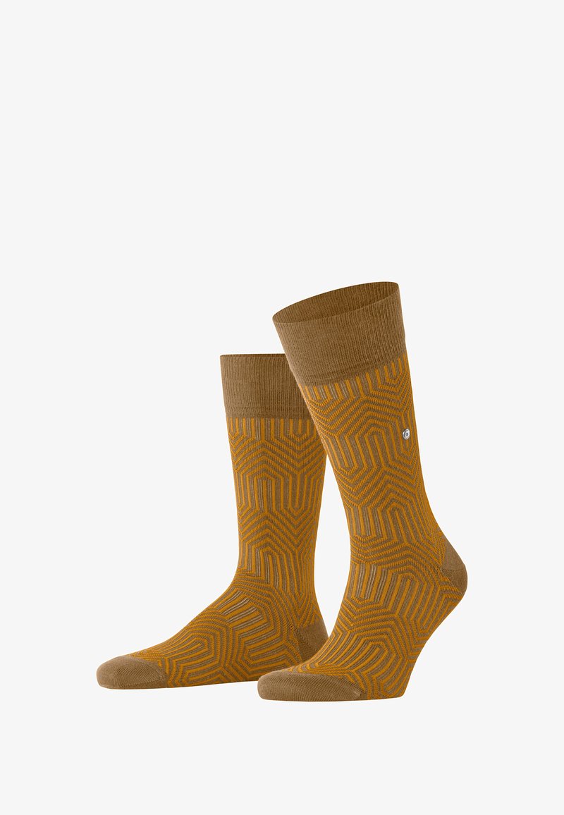 Braune Socken mit geometrischem Muster in Gelb und Grau. Gerippter Bund, mittlere Höhe, strukturiertes Gewebe sowie verstärkter Zehen- und Fersenbereich.