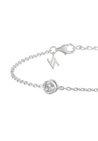 Silver chain bracelet featuring a round bead with a clear stone, lobster clasp closure, and a small logo charm attached.