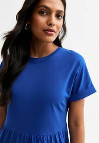 Blue short-sleeve dress with a round neckline and gathered skirt detail, made of smooth fabric with a soft texture and subtle sheen.
