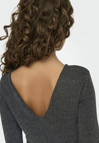 Robe bodycon noire en tissu texturé avec un dos en V plongeant et des manches longues, mettant en valeur une silhouette ajustée et un léger éclat.