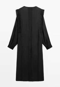 Black long-sleeve midi dress with lace shoulder panels, cuffed sleeves, and vertical stitched detailing down the back.