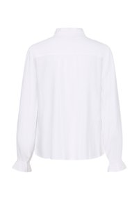 Blouse blanche à manches longues avec un col montant et un léger détail de volants aux poignets, vue de dos.