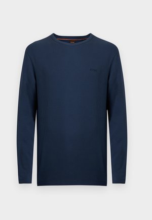 Camisola de malha azul marinho de mangas compridas com gola redonda, acabamento texturizado, bordado discreto do logotipo e corte clássico. Tecido macio, gola canelada.
