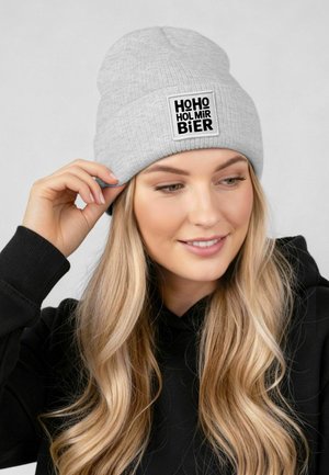 Gray knit beanie with a turned-up cuff featuring a square patch with black text "HOHO HOLMIR BIER." Soft texture, casual design.