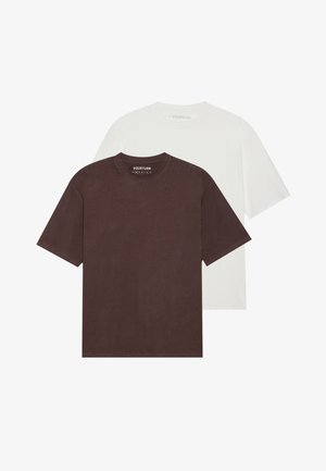 Due magliette a manica corta con collo rotondo, una marrone e una bianca, realizzate in cotone. Mostrate distese, con il marchio visibile all'interno del collo.