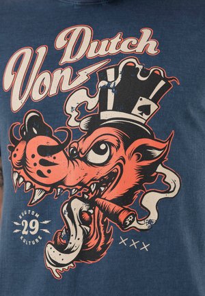 T-shirt en coton bleu avec un graphique d'un loup caricatural portant une couronne, tenant un cigare, et un lettrage "Von Dutch" en rouge audacieux.