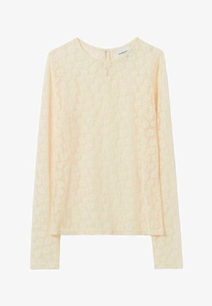 Top in pizzo beige a maniche lunghe con motivo floreale, scollatura rotonda e chiusura con piccolo bottone sul retro.
