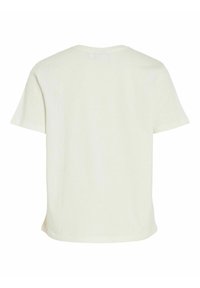 Camiseta de color crema, de manga corta y con un escote redondo, de corte relajado. Textura suave, costuras discretas y sin patrones visibles.