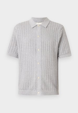 Gray knitted short-sleeve polo shirt with a textured pattern, five buttons down the front, and a soft collar.