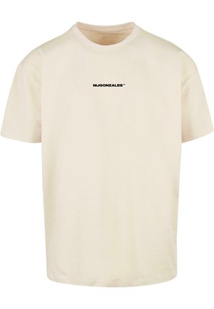 Camiseta de color crema hecha de algodón, con mangas cortas y cuello redondo. Incluye un logo impreso en negro en la parte frontal.