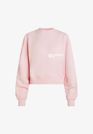 Hellrosa Crop-Sweatshirt mit langen Ärmeln und Rippbündchen, mit kleinem weißen "KARL LAGERFELD JEANS"-Schriftzug auf der Brust.